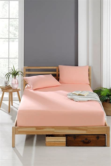 Galerie de imagini cu diverse modele de cearșafuri cu elastic, prezentând diferite culori, imprimeuri și texturi.