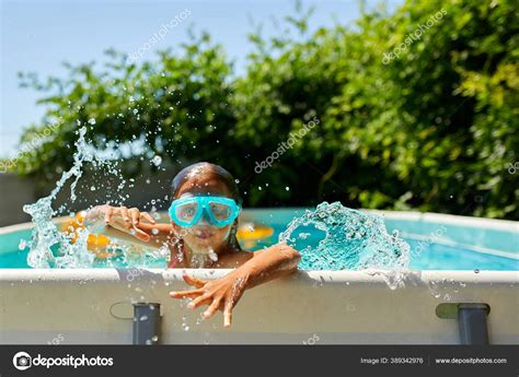 Copil fericit purtând un scutec de apă tip chilotei în piscină