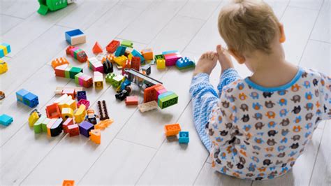 Copil distras de o jucărie în timpul schimbării scutecului